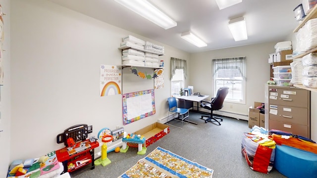 playroom featuring a baseboard radiator and baseboards