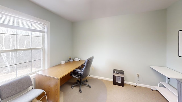 office area with baseboards and light carpet