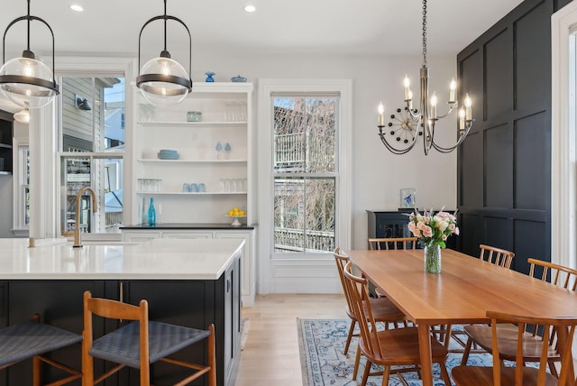 dining space with recessed lighting, light wood finished floors, and a chandelier