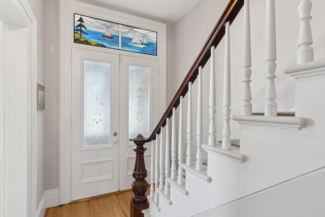 foyer entrance featuring stairs and light wood-style floors