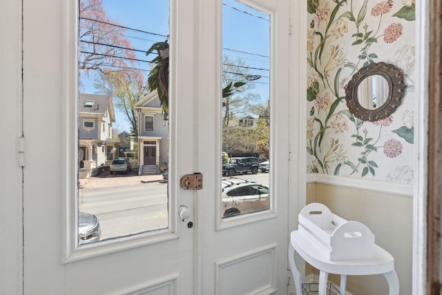 doorway with french doors and wallpapered walls