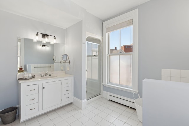 bathroom featuring vanity, tile patterned floors, baseboards, a shower stall, and a baseboard radiator