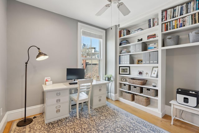 office featuring light wood-style floors, baseboards, and ceiling fan