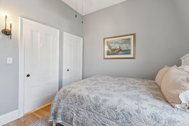 bedroom featuring baseboards and wood finished floors