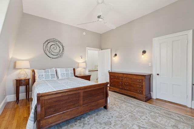 bedroom featuring baseboards, a ceiling fan, and light wood finished floors