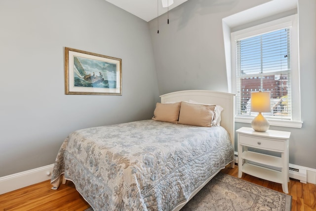 bedroom with baseboards and wood finished floors