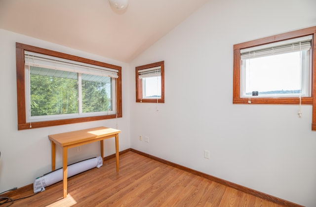 4 Tabert Ln, Belgrade, ME 04917 - bedroom featuring vaulted ceiling, a baseboard radiator, baseboards, and light wood-style floors