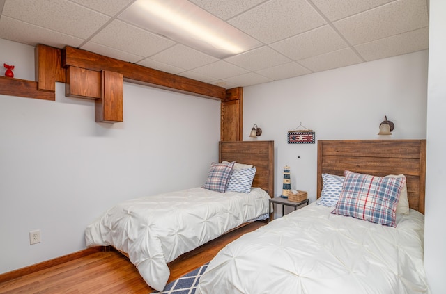 4 Tabert Ln, Belgrade, ME 04917 - bedroom featuring wood finished floors, a paneled ceiling, and baseboards