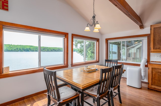 4 Tabert Ln, Belgrade, ME 04917 - dining space featuring a chandelier, vaulted ceiling, light wood finished floors, and a water view