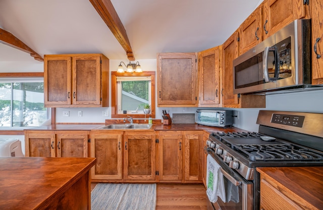 4 Tabert Ln, Belgrade, ME 04917 - kitchen featuring stainless steel appliances, beamed ceiling, wood counters, and plenty of natural light