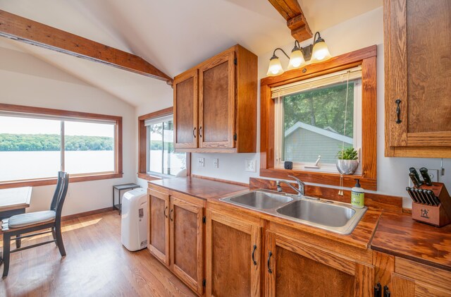 4 Tabert Ln, Belgrade, ME 04917 - kitchen with plenty of natural light, light wood-style floors, brown cabinetry, and dark countertops