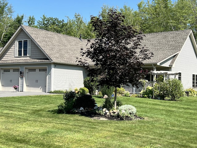 view of property exterior with driveway, a garage, a yard, and a shingled roof