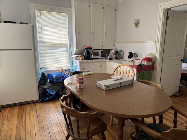 6 Spring St, Waterville, ME 04901 - kitchen with freestanding refrigerator, white cabinets, light wood-style floors, and light countertops