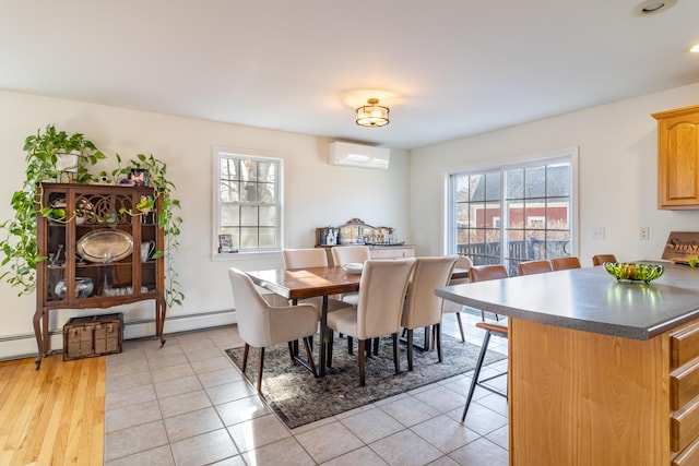 dining space with light tile patterned floors, a wall mounted air conditioner, and a baseboard radiator
