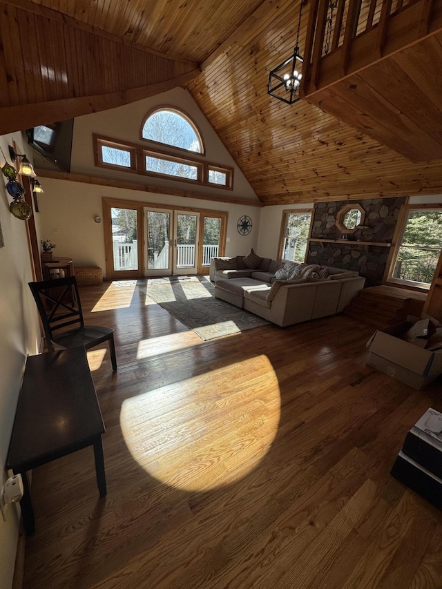 living room featuring high vaulted ceiling, wood finished floors, beamed ceiling, wooden ceiling, and a notable chandelier
