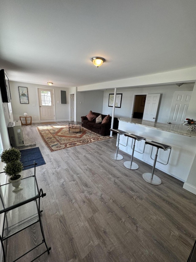 living area featuring baseboards and wood finished floors