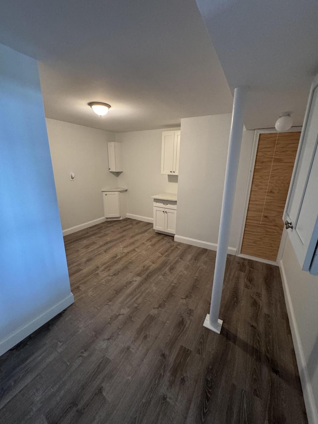 basement with dark wood finished floors and baseboards