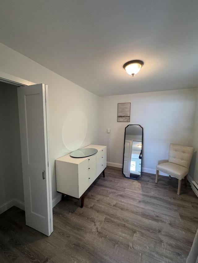interior space with dark wood-type flooring and baseboards