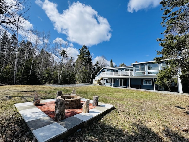 view of yard featuring a wooden deck and an outdoor fire pit