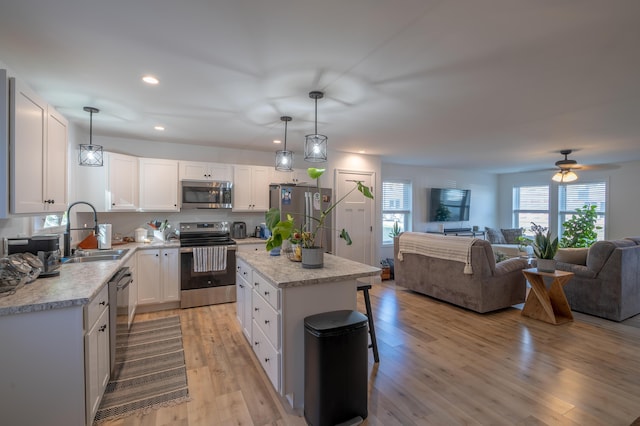 39 Firefly Ln, Bangor, ME 04401 - kitchen featuring stainless steel appliances, open floor plan, light countertops, recessed lighting, and white cabinetry