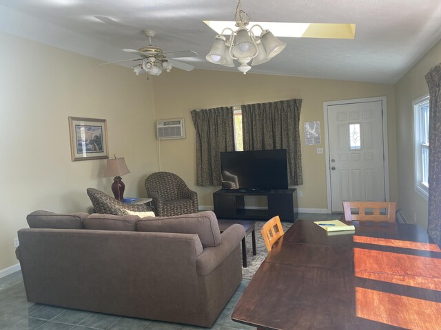 22 Ocean Park Rd Unit 136, Saco, ME 04072 - living room featuring ceiling fan with notable chandelier, baseboards, an AC wall unit, and lofted ceiling with skylight