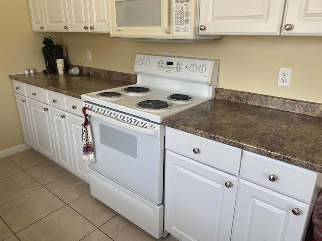 22 Ocean Park Rd Unit 136, Saco, ME 04072 - kitchen with white cabinets, dark countertops, white appliances, and light tile patterned flooring