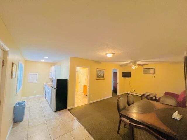 22 Ocean Park Rd Unit 136, Saco, ME 04072 - living area with an AC wall unit, baseboards, ceiling fan, and light tile patterned floors
