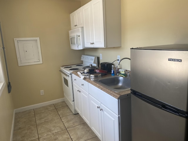 22 Ocean Park Rd Unit 136, Saco, ME 04072 - kitchen with white cabinets, light tile patterned floors, a sink, white appliances, and electric panel