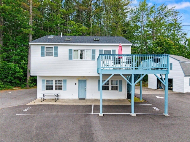 22 Ocean Park Rd Unit 136, Saco, ME 04072 - view of front of property with a deck, uncovered parking, and view of wooded area