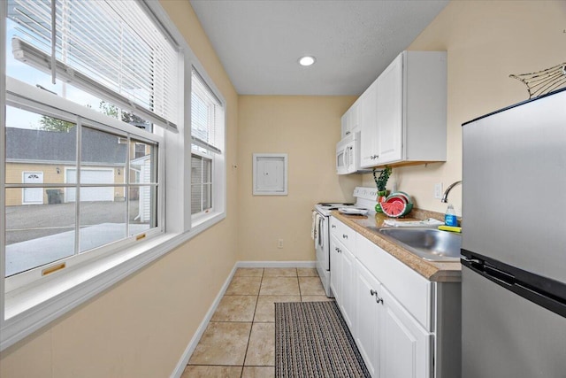 22 Ocean Park Rd Unit 136, Saco, ME 04072 - kitchen featuring white appliances, white cabinets, light tile patterned floors, plenty of natural light, and recessed lighting