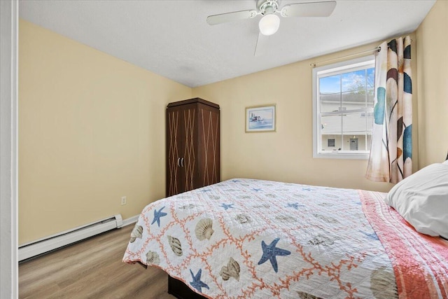 22 Ocean Park Rd Unit 136, Saco, ME 04072 - bedroom featuring a baseboard radiator, wood finished floors, and ceiling fan