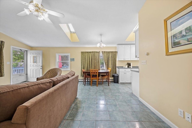 22 Ocean Park Rd Unit 136, Saco, ME 04072 - living room with a skylight, ceiling fan, a chandelier, and vaulted ceiling