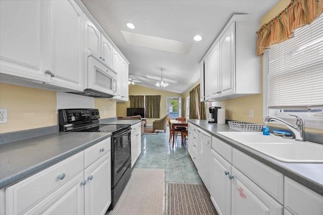 22 Ocean Park Rd Unit 136, Saco, ME 04072 - kitchen with white appliances, a skylight, white cabinetry, lofted ceiling, and recessed lighting
