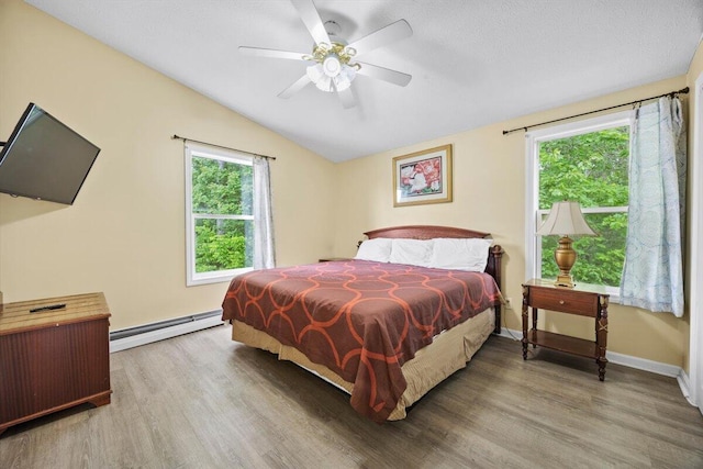 22 Ocean Park Rd Unit 136, Saco, ME 04072 - bedroom with baseboard heating, wood finished floors, vaulted ceiling, and ceiling fan