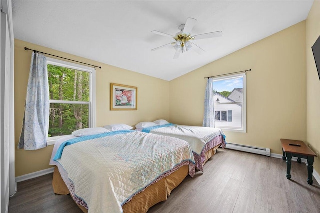 22 Ocean Park Rd Unit 136, Saco, ME 04072 - bedroom featuring a baseboard heating unit, vaulted ceiling, wood finished floors, and a ceiling fan
