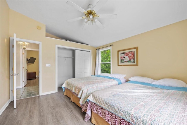 22 Ocean Park Rd Unit 136, Saco, ME 04072 - bedroom with wood finished floors, vaulted ceiling, a closet, and a ceiling fan