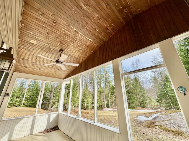 52 Main Rd, Chesterville, ME 04938 - unfurnished sunroom with a ceiling fan, lofted ceiling, and view of wooded area