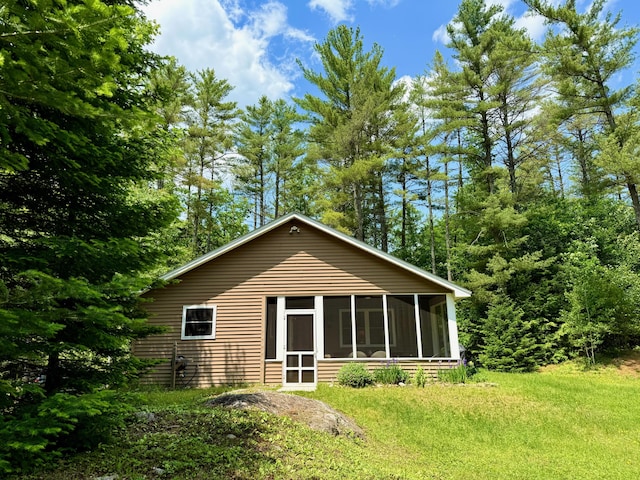 52 Main Rd, Chesterville, ME 04938 - rear view of property featuring a sunroom and a lawn