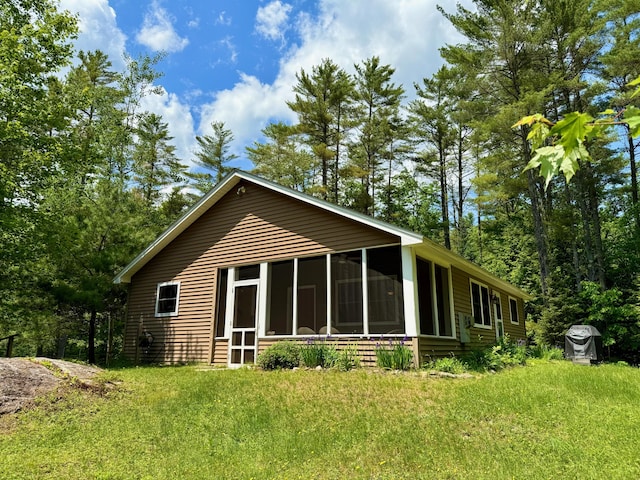 52 Main Rd, Chesterville, ME 04938 - rear view of house featuring a sunroom and a lawn