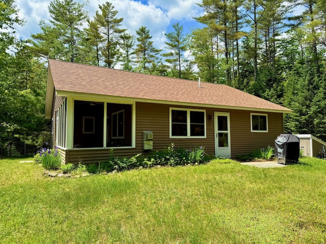 52 Main Rd, Chesterville, ME 04938 - back of property featuring a lawn, roof with shingles, and a sunroom