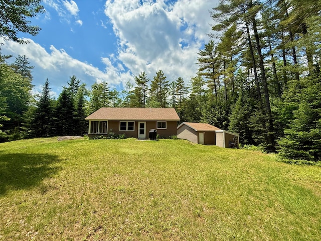 52 Main Rd, Chesterville, ME 04938 - view of front of property with a front yard, an outbuilding, and a garage