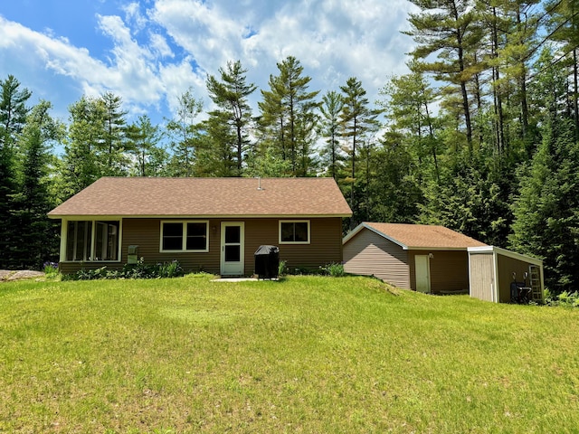52 Main Rd, Chesterville, ME 04938 - view of front of house featuring a front lawn, a storage unit, and roof with shingles