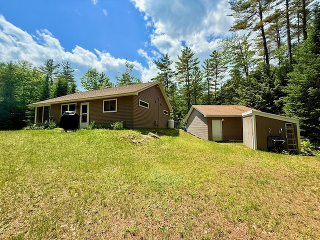 52 Main Rd, Chesterville, ME 04938 - rear view of house featuring an outdoor structure and a lawn