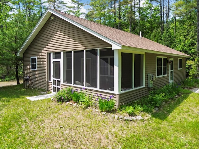 52 Main Rd, Chesterville, ME 04938 - rear view of house with a sunroom, a lawn, and roof with shingles