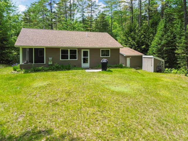 52 Main Rd, Chesterville, ME 04938 - back of house with a storage unit, a lawn, and roof with shingles
