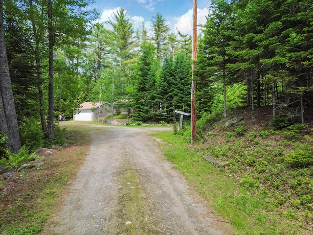 52 Main Rd, Chesterville, ME 04938 - view of dirt / gravel driveway featuring a wooded view