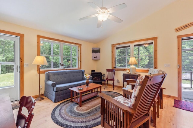 52 Main Rd, Chesterville, ME 04938 - living area with a wood stove, light wood-type flooring, vaulted ceiling, and a ceiling fan