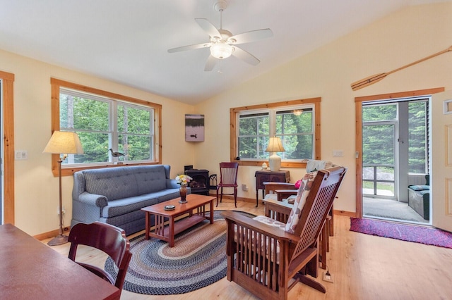 52 Main Rd, Chesterville, ME 04938 - living room featuring a wood stove, lofted ceiling, light wood-type flooring, and a ceiling fan
