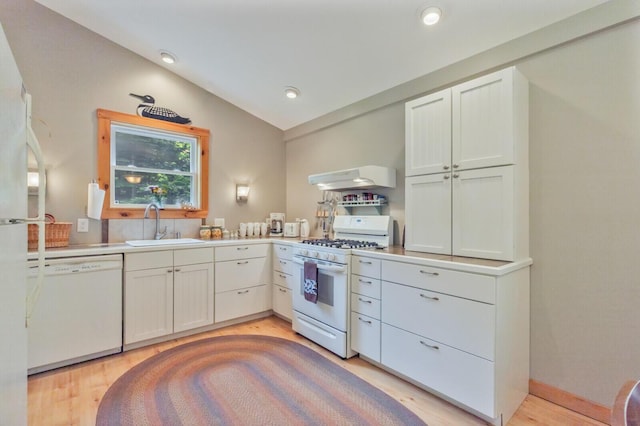52 Main Rd, Chesterville, ME 04938 - kitchen with white appliances, range hood, light wood-type flooring, light countertops, and vaulted ceiling