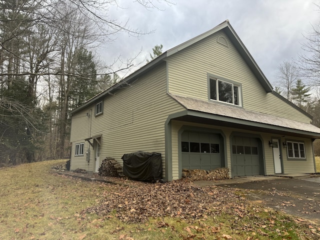 2 Mountain View Ln, Readfield, ME 04355 - view of side of home featuring driveway and a garage